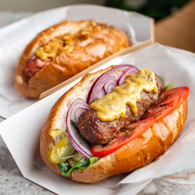 Close up of hot dog Fast food Diagonal composition It lies on a black slate