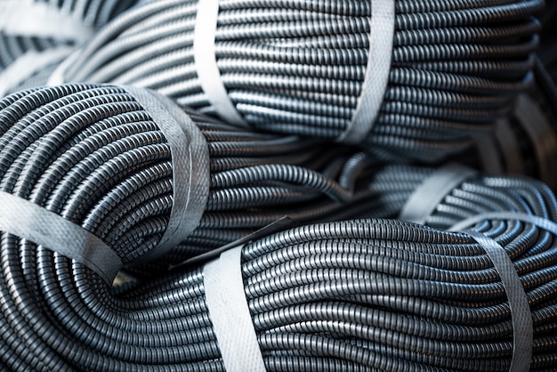 Close-up of a huge bundle of metal flexible tubes interconnected in a factory or industry plant. The concept of modern mining or IT of high-tech industries