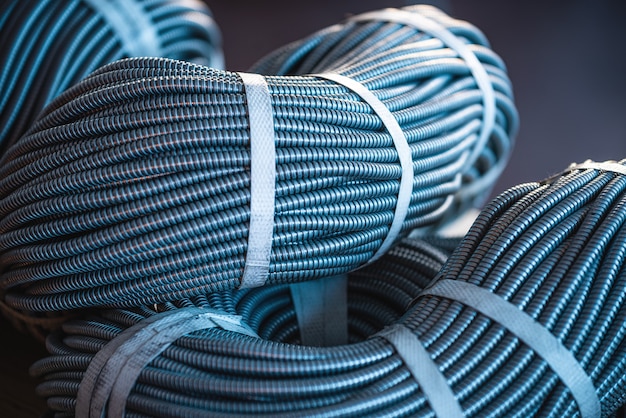 Close-up of a huge bundle of metal flexible tubes interconnected in production. The concept of modern electronic high voltage devices and specialized production