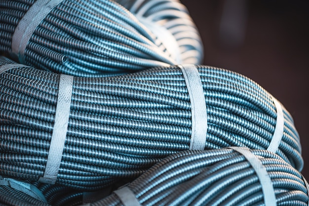 Close-up of a huge bundle of metal flexible tubes interconnected in production. The concept of modern electronic high voltage devices and specialized production