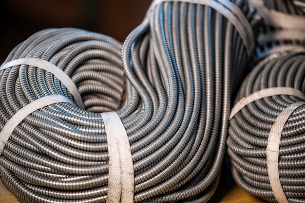 Close-up of a huge bundle of metal flexible tubes interconnected in production. The concept of modern electronic high voltage devices and specialized production