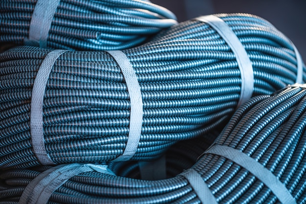 Close-up of a huge bundle of metal flexible tubes interconnected in production. The concept of modern electronic high voltage devices and specialized production