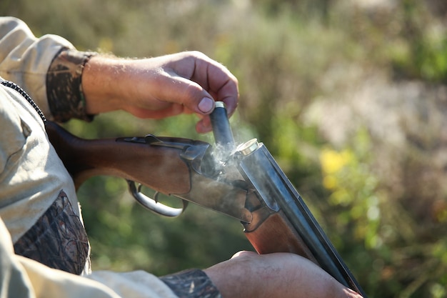 Close up on hunter holding a hunting rifle