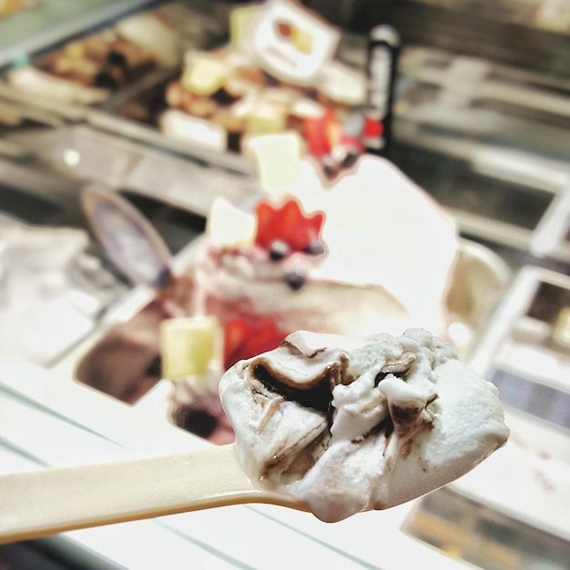 Photo close-up of ice cream on spoon at store