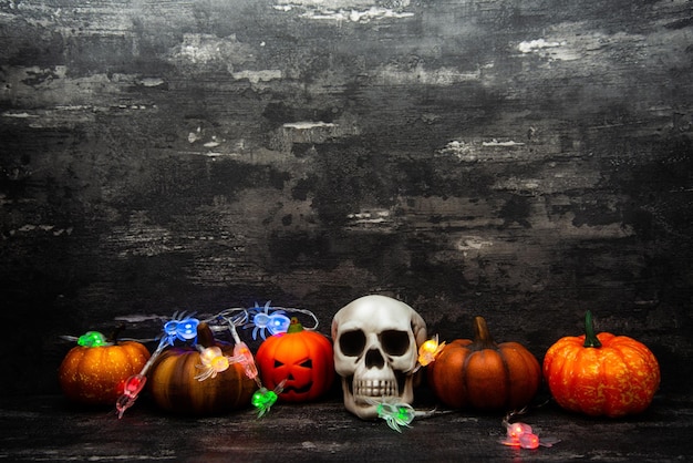 Close-up of illuminated jack o lantern and string lights in dark