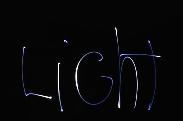 Photo close-up of illuminated lighting equipment against black background