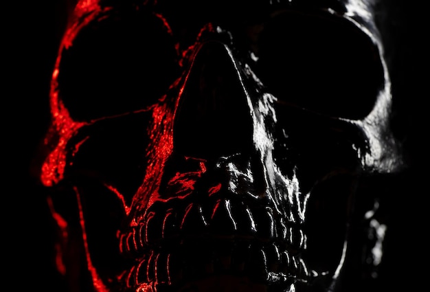 Close-up of illuminated spooky skull against black background