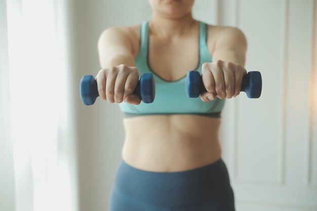 Close up image of attractive fit woman in gym