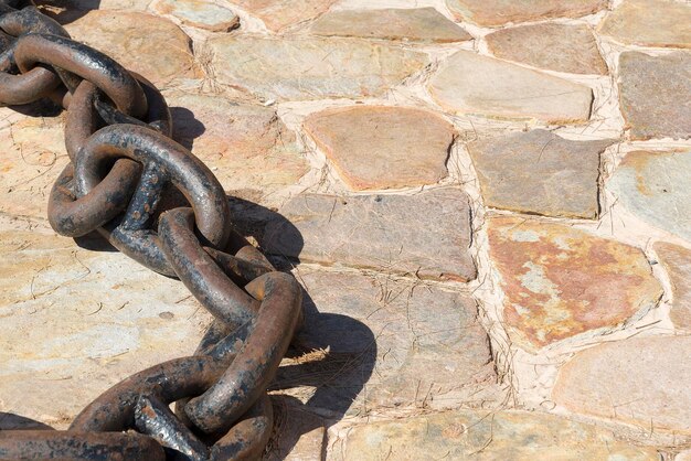 The close up image of chain hook on the dirt ground