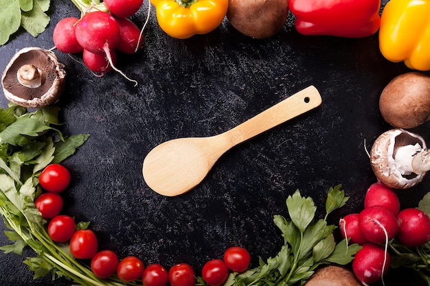 Close up image of different delicious fresh and healthy vegetables on dark background in studio photo