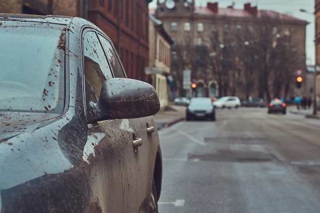 Close-up image of a dirty car after a trip around the countryside