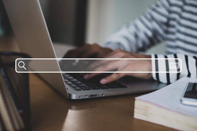 Close up image hand of young businessman using laptop with search engine icon and use the search engine menu to find information on the Internet