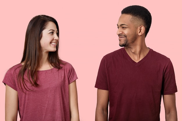 Close up image of happy young couple looking face to face at each other