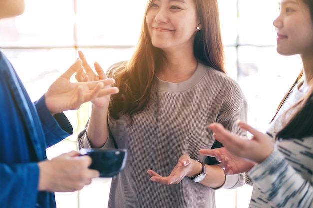 Close up image of people enjoyed talking and drinking coffee together