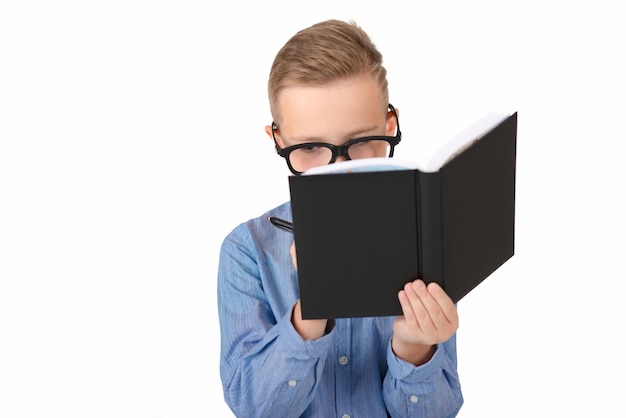 Close up imageAttractive caucasian schoolboy holding a notebook pen in hands isolated on a white