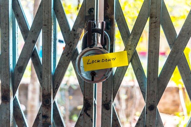 Photo close-up of information sign hanging on fence covid lockdown corona virus themes