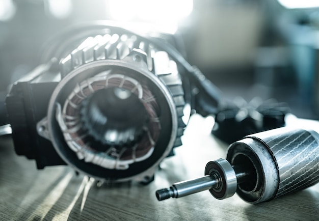 Close-up of an iron industrial motor lies on a table during the production of new modern trucks in a factory. The concept of reliable and high-quality special cars