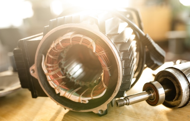 Close-up of an iron industrial motor lies on a table during the production of new modern trucks in a factory. The concept of reliable and high-quality special cars