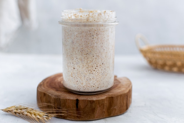 Close-up of jar with natural homemade sourdough levain starter for homemade bakery