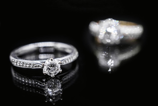 Close up Jewelry diamond ring on black background with reflection