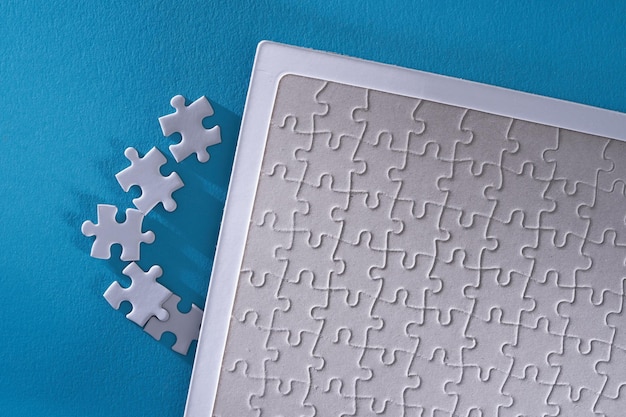 Close up jigsaw puzzle on blue background