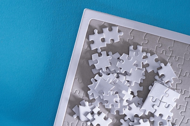 Close up jigsaw puzzle on blue background