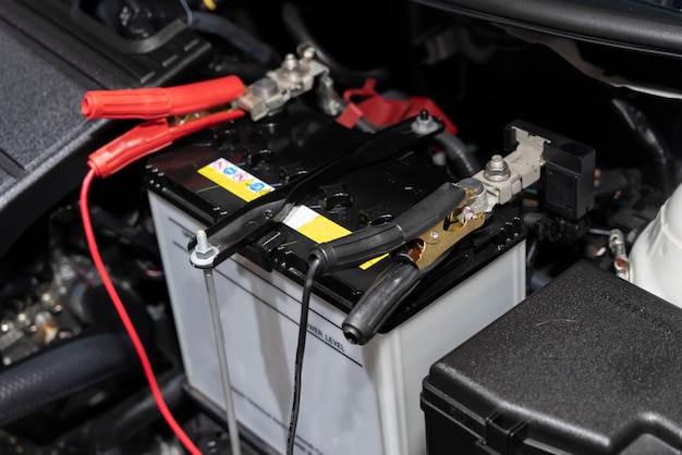 Close-up on jumper cables on car battery