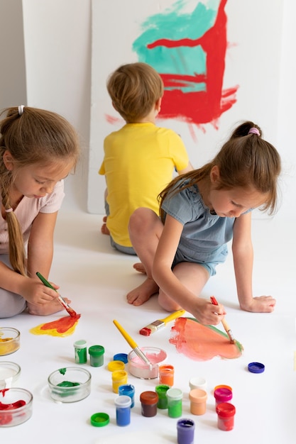 Close up kids painting with colours