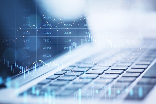 Close up of laptop with abstract glowing big data forex candlestick chart on blurry background Trade technology investment and analysis concept Double exposure