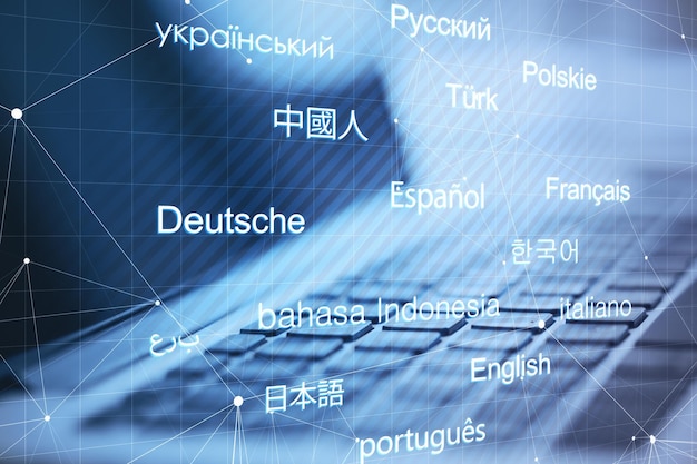 Photo close up of laptop with creative digital languages mesh on blurry background online dictionary and translation concept double exposure