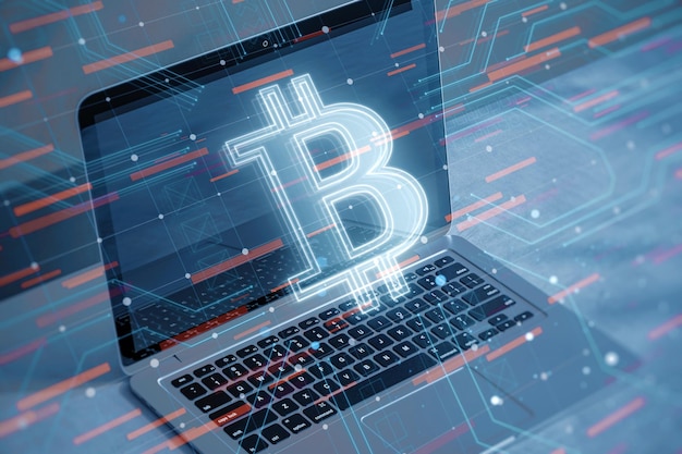 Close up of laptop with glowing bitcoin hologram on blurry desktop background Cryptocurrency and finance concept Double exposure