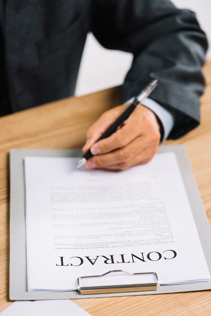 Close-up of lawyer's hand signing an official document