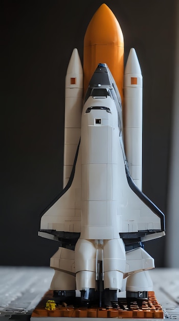 a close up of a lego space shuttle with a yellow rocket