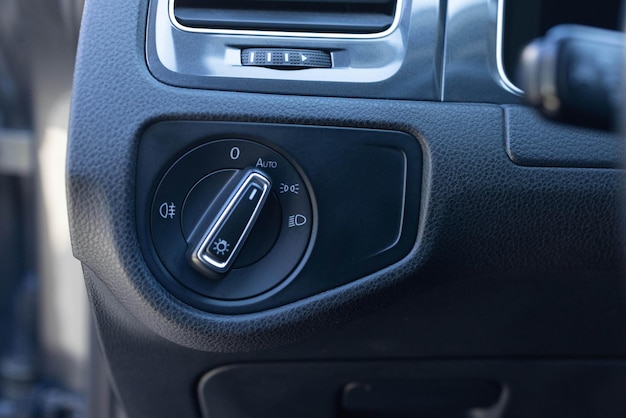 Close up of light control in car headlight switch fog lights automatic control of switching on