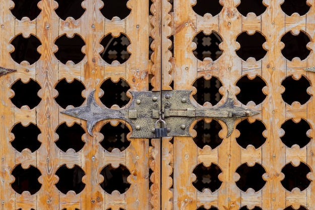 Close up locked carved wooden gate