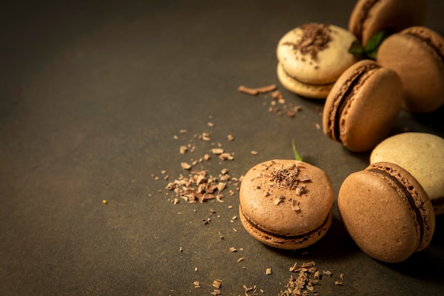 Close-up of macarons cakes of different colors in blue background. Culinary and cooking concept. Tasty colourful macaroons.