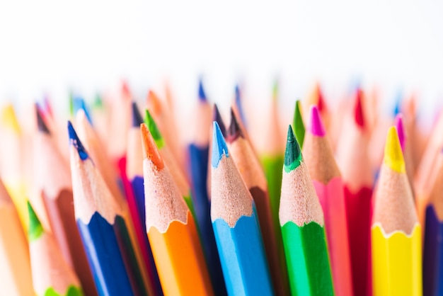 Close up macro shot of color pencil pile pencil nibs on white background.