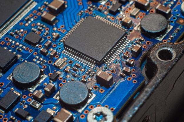 Close-up Macro Shot of Electronic Factory Machine at Work: Printed Circuit Board Being Assembled with