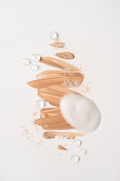 Close up of make up cosmetic products neutral beige and white beauty cream powder foam oil isolated on white background Minimalist beauty branding merchandise concept