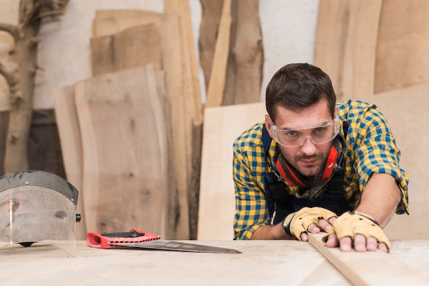 Close-up of a male carpenter working in the workshop