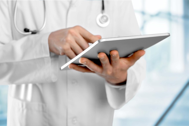 close up of male doctor holding tablet pc with x-ray