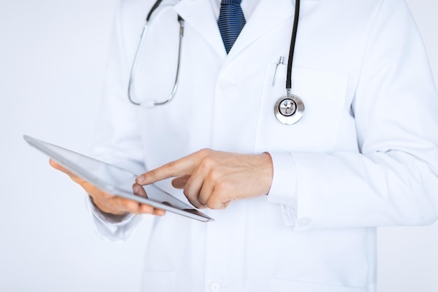 close up of male doctor holding tablet pc