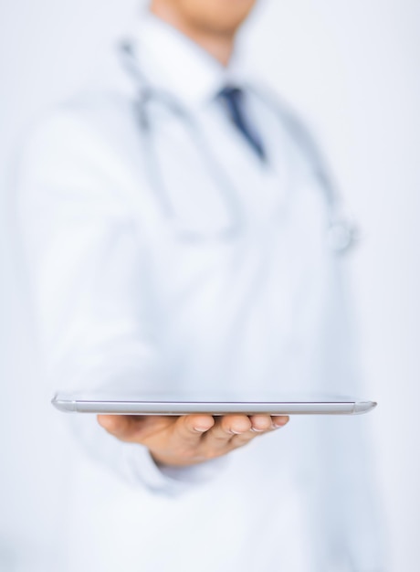 close up of male doctor holding tablet pc