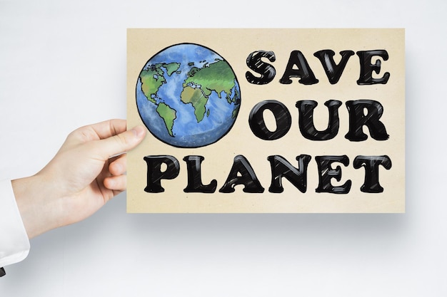 Close up of male hand holding save the planet sketch on white background Earth day concept