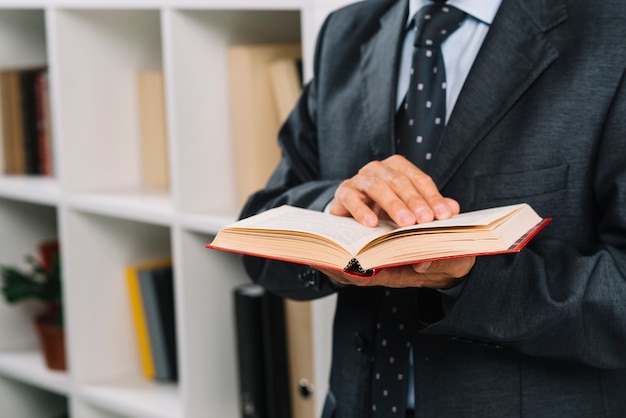 Close-up of male lawyer holding law book