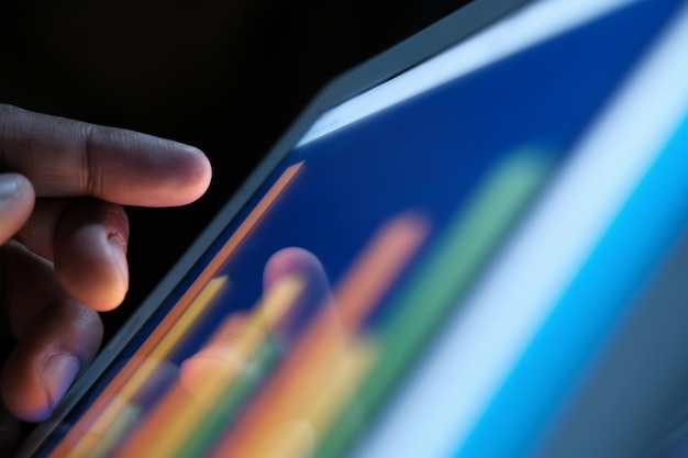 Photo close up of man hand analyzing chart on digital tablet