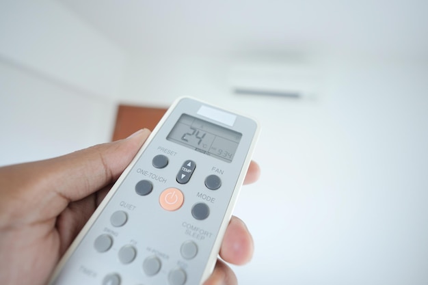 Close up of man hand holding air condition remote