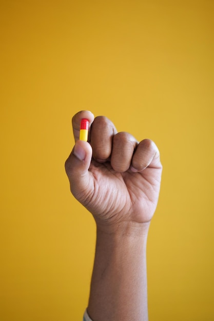 Close up of man hand holding a capsule pill