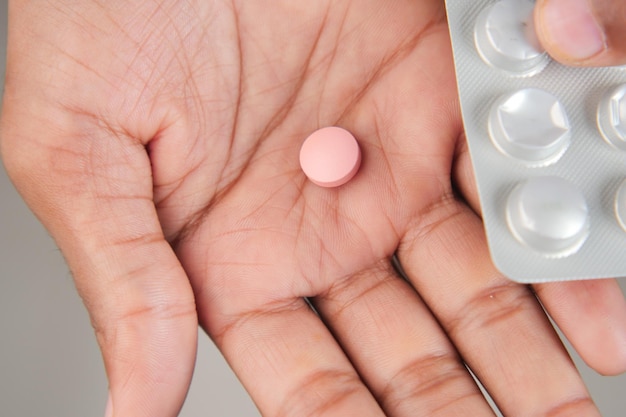 Close up of man hand holding pills with copy space