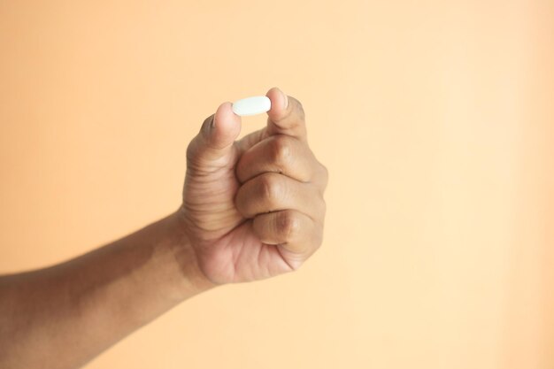 Close up of man hand holding pills with copy space